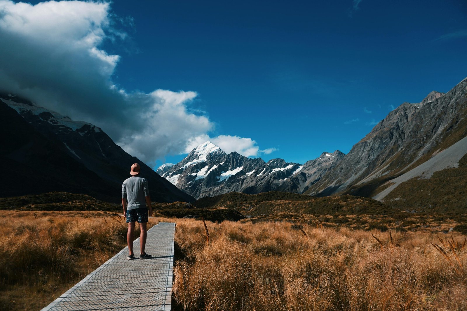 man on path to mountains